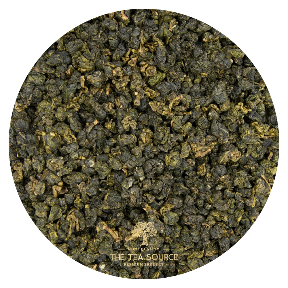 
                      
                        Close-up view of rolled green oolong tea leaves in a circular frame
                      
                    